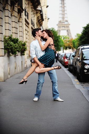 Young couple on Paris Street with the Eiffel Tower