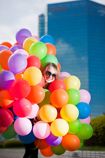 istock Woman holding many balloons 108327873