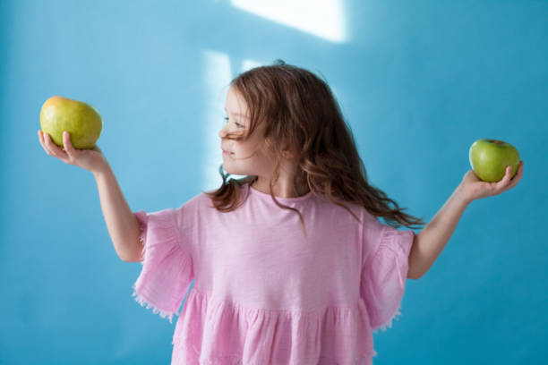 istock little girl eating a Green Apple fruit vitamins 1083279940
