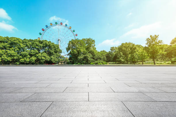 istock Empty floor and ferris wheel in green city park 1083279984