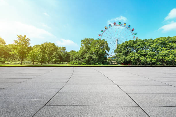 istock Empty floor and ferris wheel in green city park 1083280316