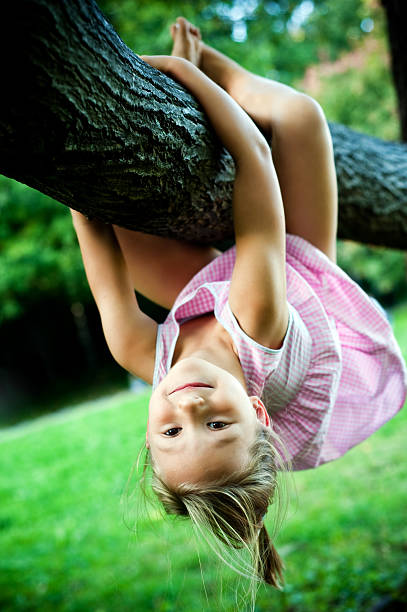 A girl goes through an obstacle course in a rope park. Leisure activities.