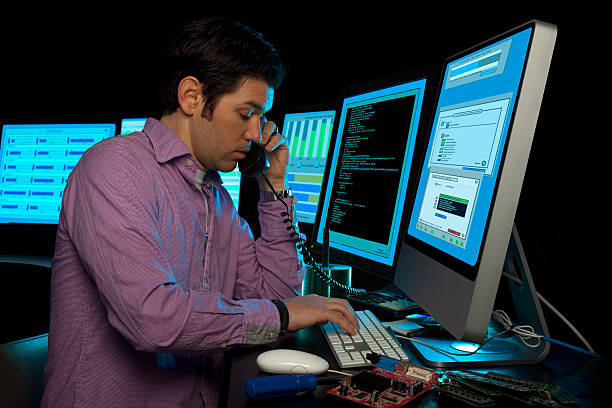 IT Data Manager Phone Support Surrounded by Computer Monitors remote support stock pictures, royalty-free photos & images