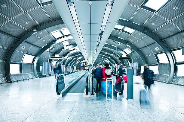 istock Airport Tunnel with Blurred Passengers on Moving Walkway 108328082