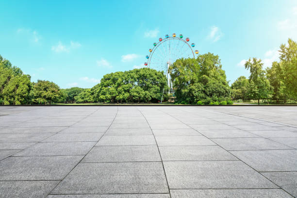 istock Empty floor and ferris wheel in green city park 1083282056