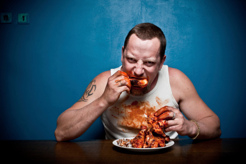 Big hungry man wildly eating grilled chicken and making big mess. Canon 1Ds Mark IIIhttp://farm5.static.flickr.com/4111/5026184198_22739aa3f6.jpg