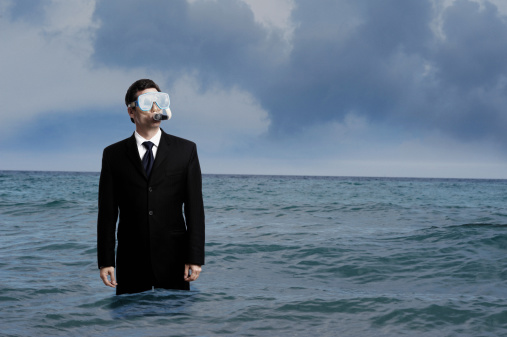 Businessman with Diving Mask and Snorkel in Ocean