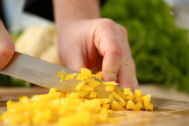 istock Cook holds knife in hand and cuts on 1083284034