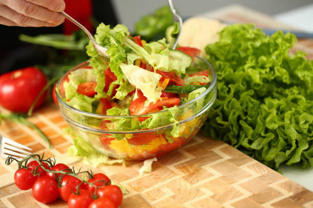istock Cook holds fork in hand and mixes 1083284150