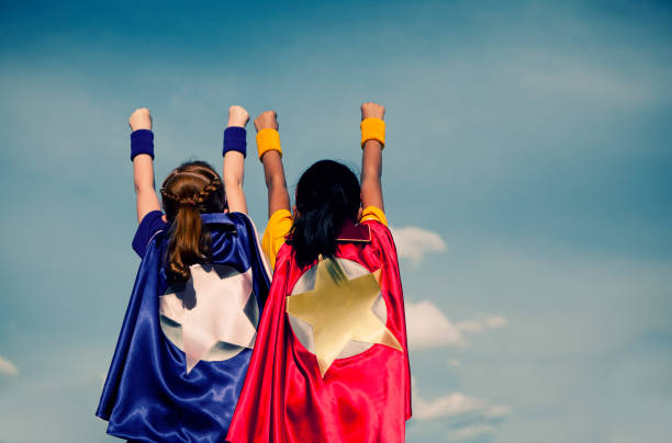 Super Girl Duo A young superhero duo. Vanquishing evil in a single afternoon. It is never too early to be super.  cape garment photos stock pictures, royalty-free photos & images