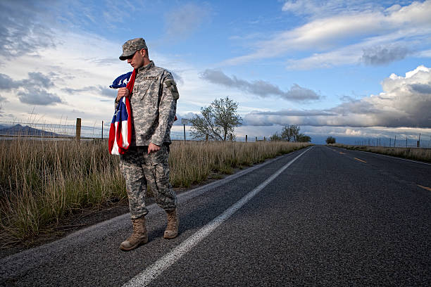 istock Lonely military soldier walking down a road 108328693