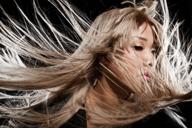 Beautiful Blonde Asian Woman With Long Blowing Hair stock photo