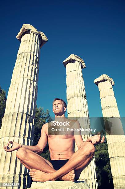 Man Meditating Outdoors Under Greek Columns Stock Photo - Download Image Now - Adult, Adults Only, Ancient