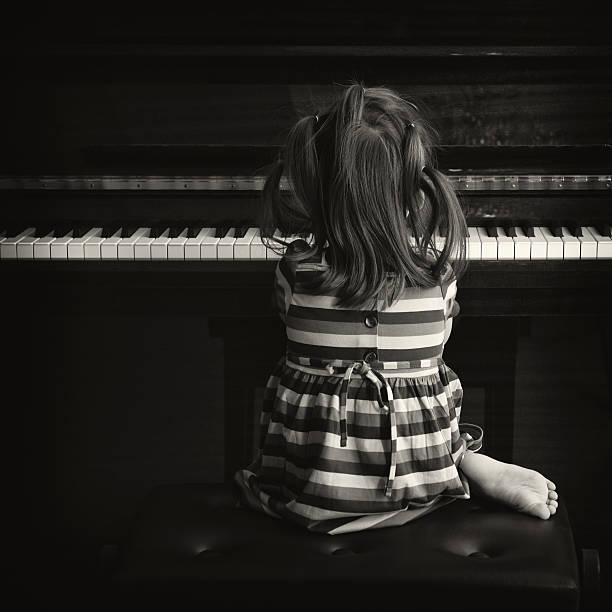 istock Little Girl Playing Piano 108328879