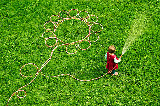 Little girl watering the garden