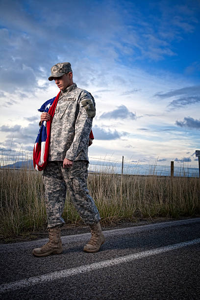 istock Lonely military soldier walking down a road 108329023