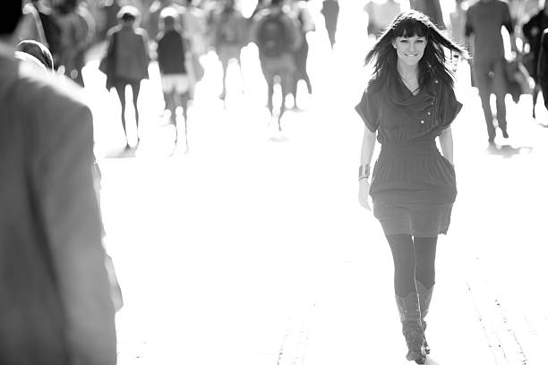 istock Confident beautiful woman striding down crowded street 108329056