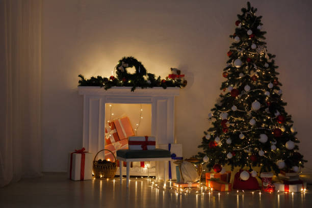 istock Christmas tree with presents and decorations the lights new year Garland 1083291084