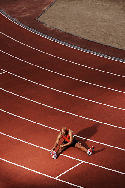 istock African American athlete stretching on running track 108329118