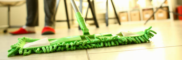 istock Green plastic mop cleaning laminated light dirty floor 1083291654