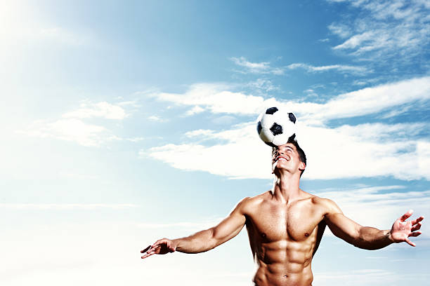 istock Shirtless muscular guy balancing football on head 108329200