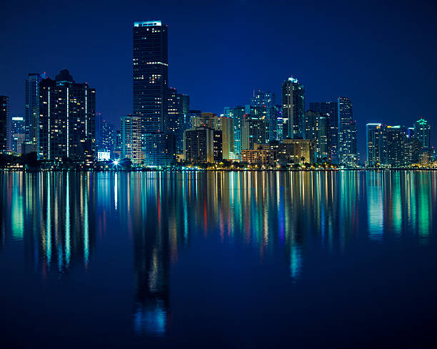 miami at night night shot of miami skyline, very calm water. - brickell area calm water photos stock pictures, royalty-free photos & images