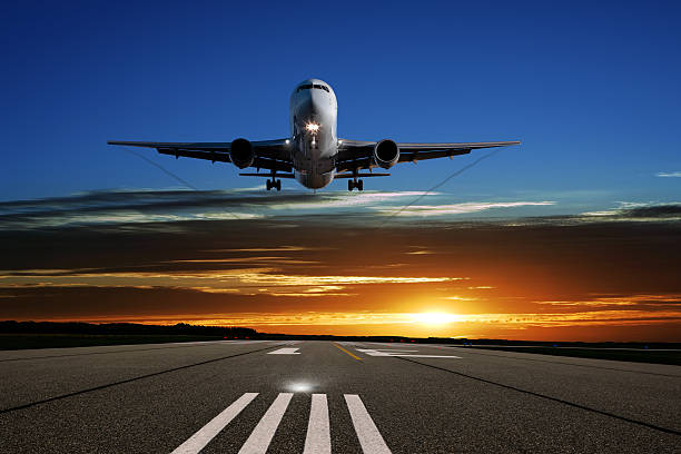 istock XL jet airplane landing at sunset 108329277