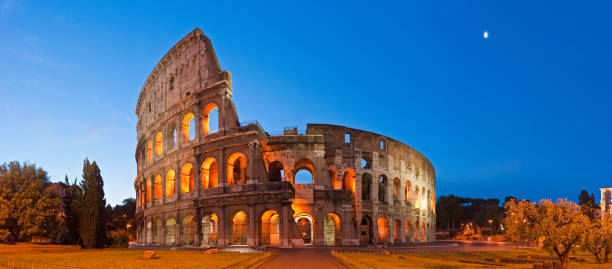 Rome Coliseum Colosseo ancient roman amphitheatre Italy panorama blue moon stock photo