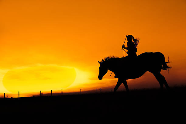 istock Woman Rides Hosreback Into The Sunset 108329422