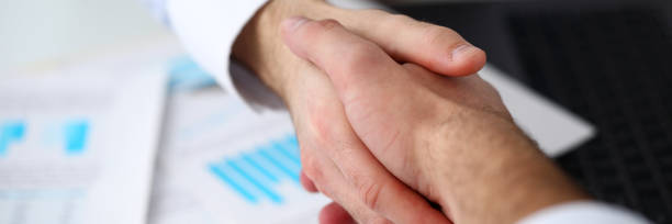 istock Man in suit and tie give hand as hello in office 1083294380