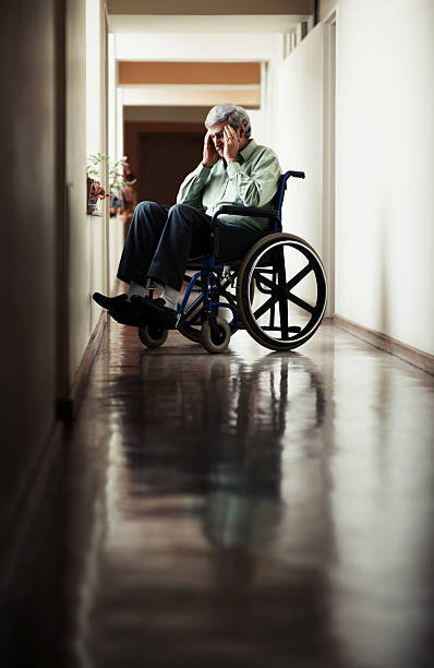 istock Senior man with headache sitting on wheelchair 108329508