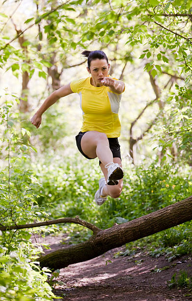 istock Woman Jumping Over Log 108329972