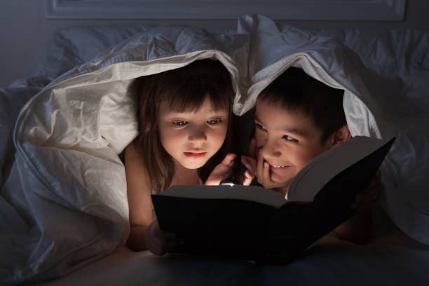 istock Kids reading in the dark 108330001