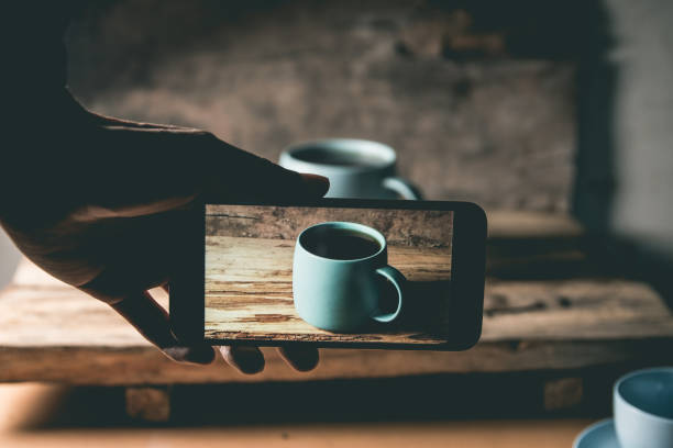 Taking a picture of a coffee cup with mobile phone