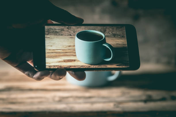 Taking a picture of a coffee cup with mobile phone