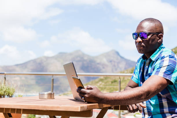 African guy texting on his smartphone