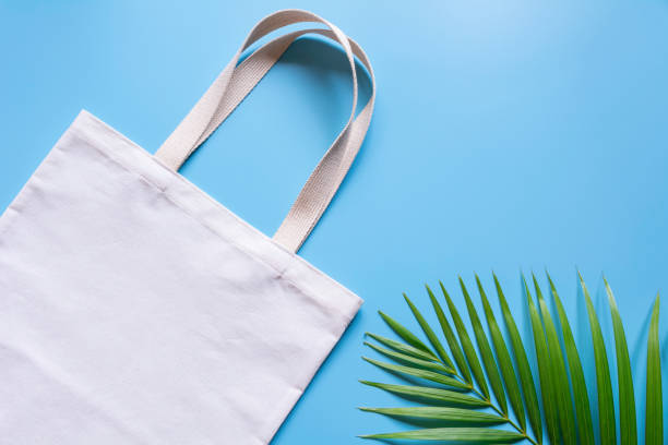 White tote bag canvas fabric. Cloth shopping sack mockup with copy space. stock photo