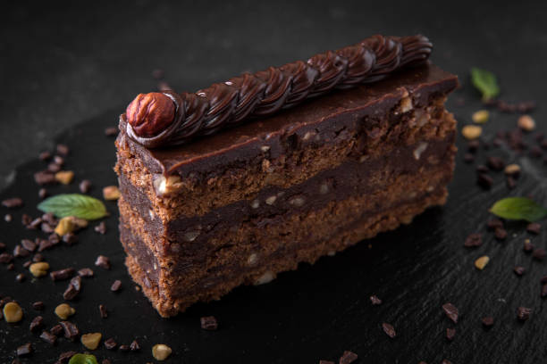 istock A piece of chocolate cake with biscuit, hazelnut and cocoa filling 1083308048