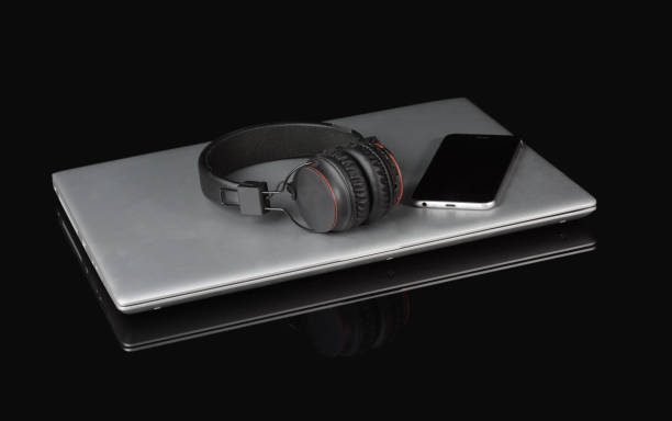 istock Laptop and head phone on black background, conceptual theme 1083309196