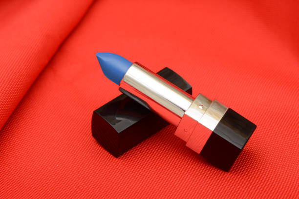 Blue color lipstick on red cloth background