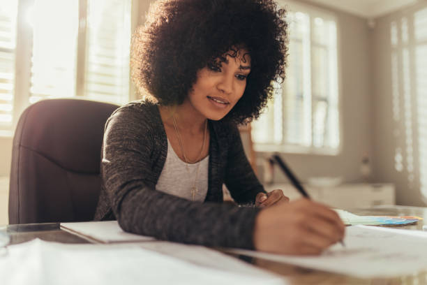 istock Architect working on new designs at her home office 1083309776