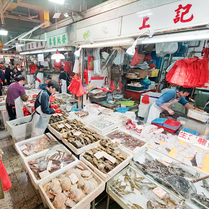 Sham Shui Po, Hong Kong - 14 December, 2018 : Customers buying seafood on the Sham Shui Po market. It's one of the largest food markets in Hong Kong.