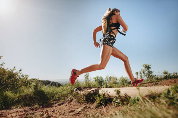 istock Female runner sprinting outdoors 1083310588