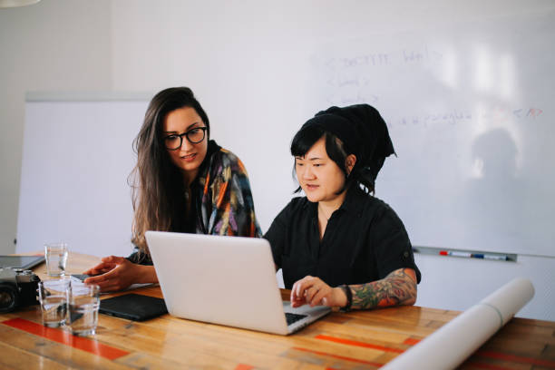 istock Young women working together in a small Berlin start-up office 1083312364