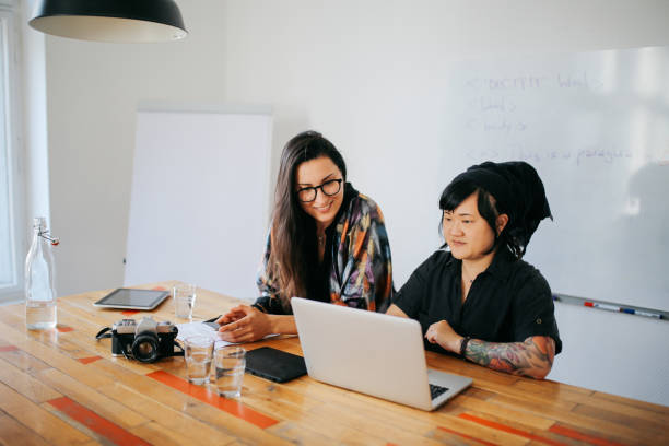 istock Young women working together in a small Berlin start-up office 1083312746