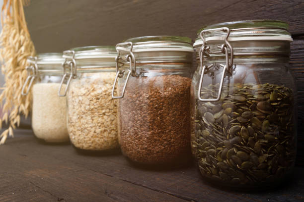 istock Various seeds in storage jars in pantry, dark wooden background. Smart kitchen organization 1083314398