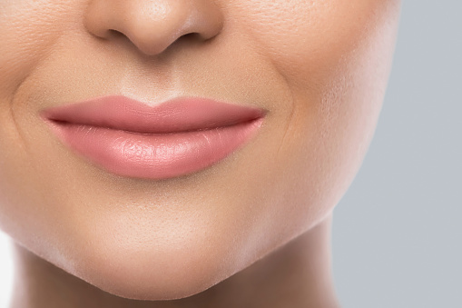 Close-up of beautiful female lips. Concept of face care or skin rejuvenation