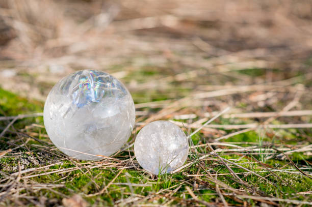 2 bolas de cuarzo cristal tendido en la hierba en un bosque en otoño - amethyst esoteric mineral the natural world fotografías e imágenes de stock