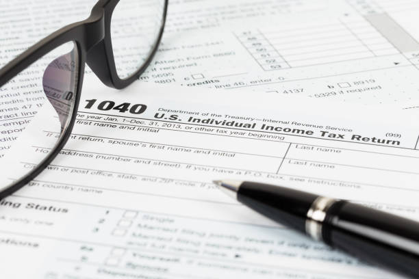 istock Tax form with glasses, and pen 1083320872