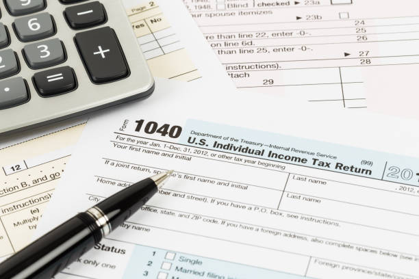 istock Tax form with pen and calculator 1083320874